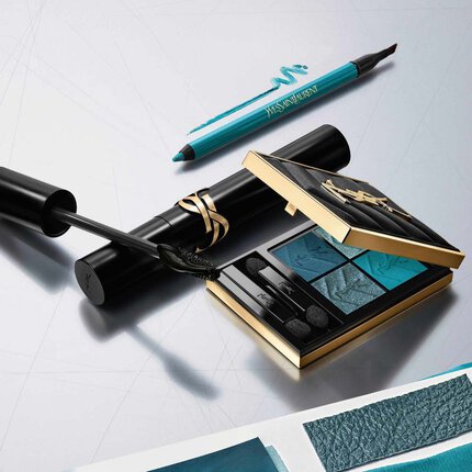 Collection de maquillage de luxe YSL : palette de fards bleue, mascara et eye-liner sur fond argente.