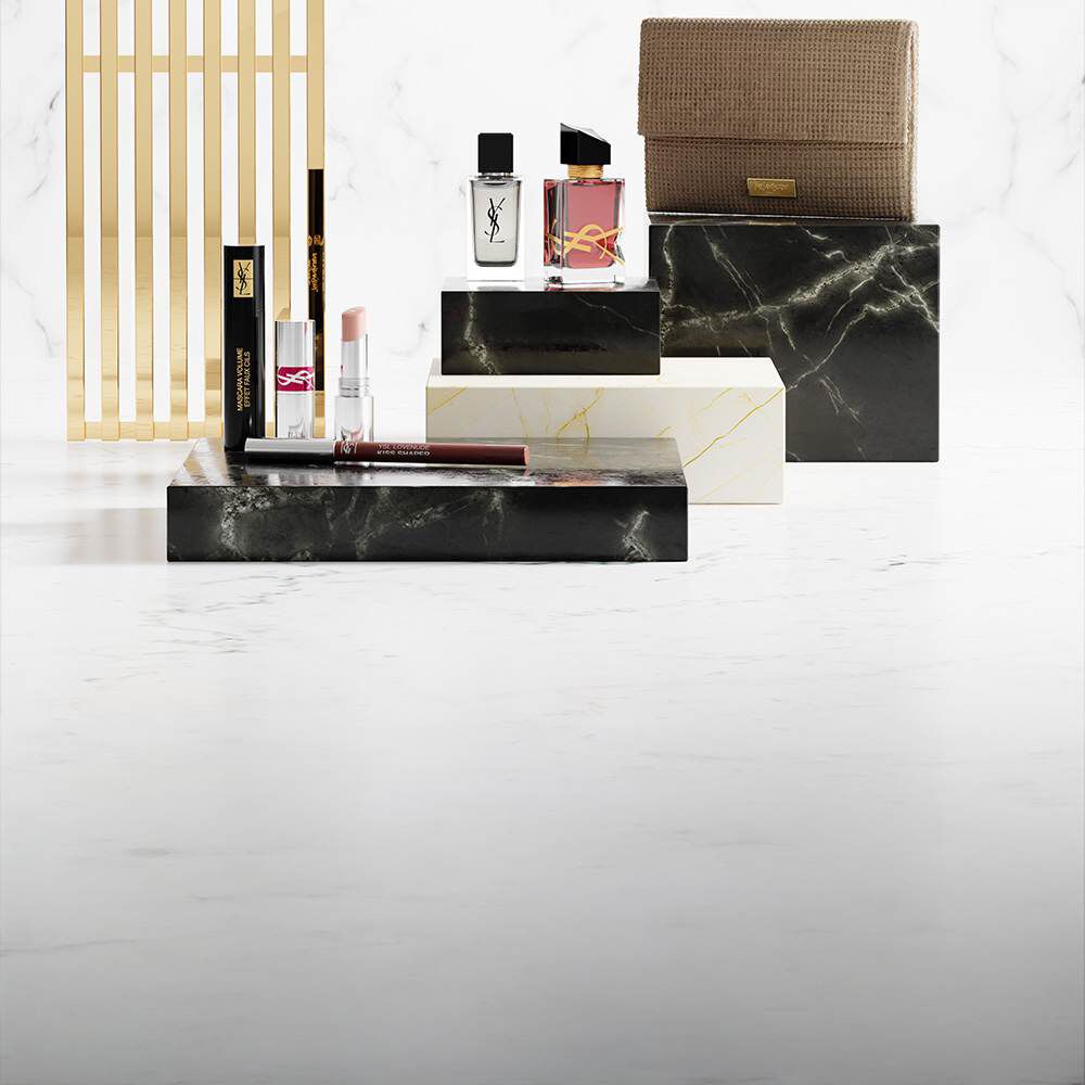 Produits de beaute YSL sur socles en marbre de luxe.