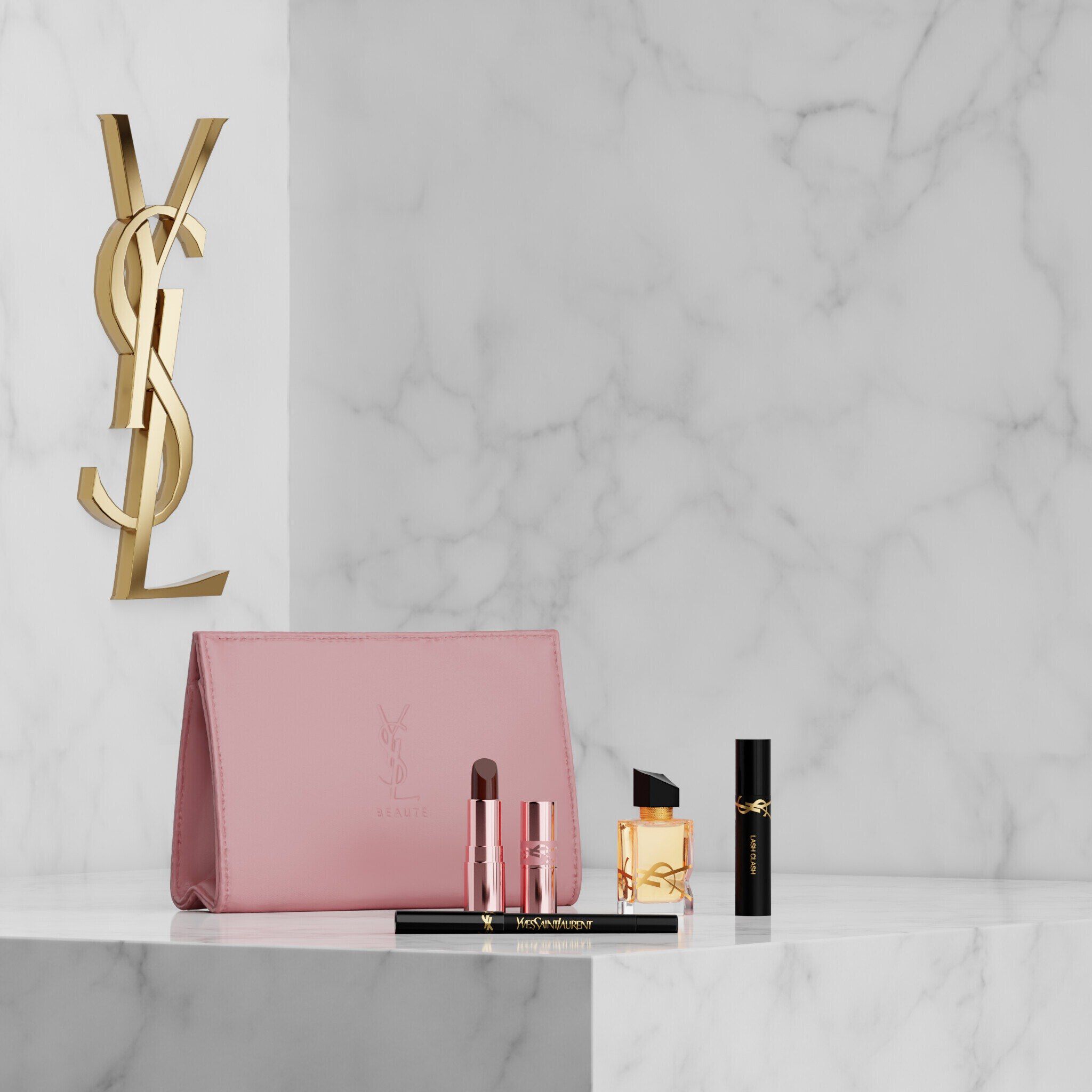 Coffret YSL Beauty avec trousse rose, rouge a levres, eyeliner, mascara et mini parfum sur etagere en marbre.