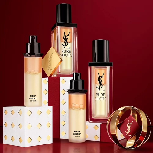 Flacons de serum YSL Pure Shots Night Reboot et emballages festifs.