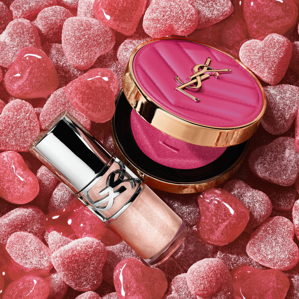 YSL LOVESHINE Plumping Lip Oil Gloss shade 10 and Make Me Blush shade 66, amidst vibrant pink heart-shaped sweets.