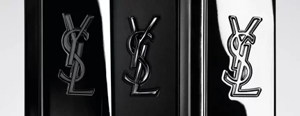 Trois flacons de parfum YSL noirs sur fond clair