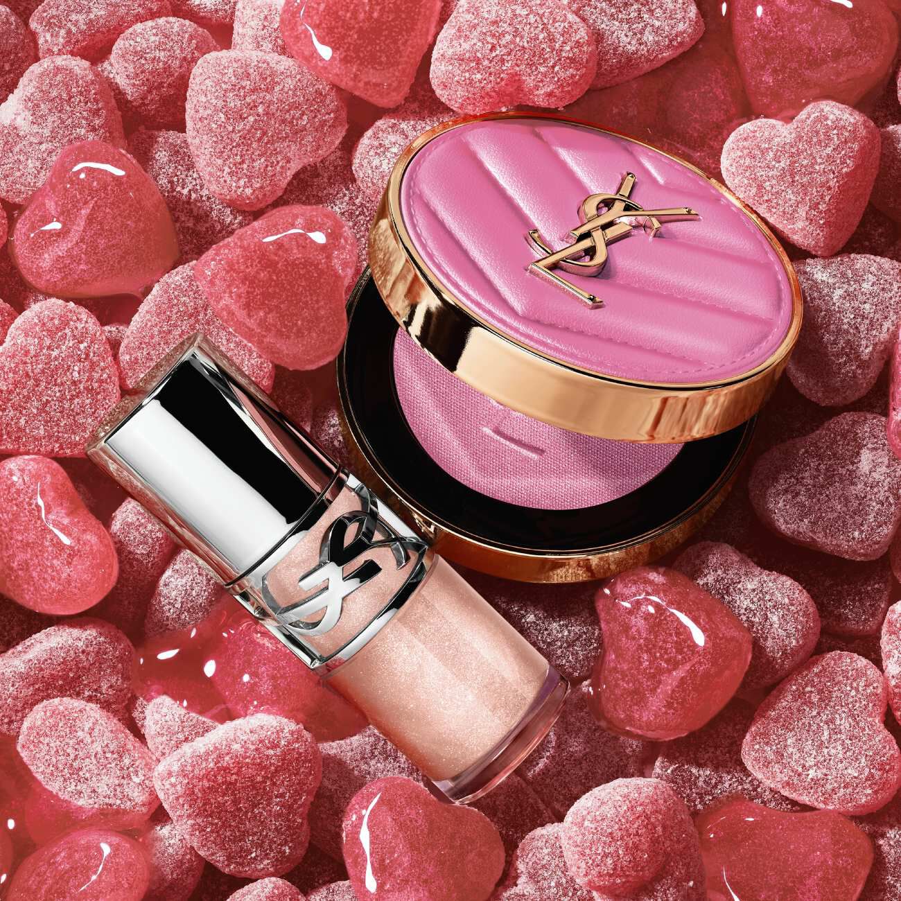 YSL Make Me Blush Powder Blush and LOVESHINE Plumping Lip Oil Gloss in shade 10, nestled among pink heart-shaped candie