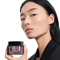 Wen, YSL Beauty model, holding Pure Shots Youth Reload cream, highlighting skin-reshaping claims.