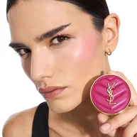Iman, medium skin, holding a fuchsia YSL Make Me Blush Powder Blush in shade 66, showcasing vibrant blush on her cheek.