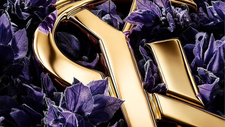 YSL LIBRE gold Cassandre logo amidst purple lavender, highlighting the fragrance's key ingredient.